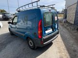 a blue van that is parked in a parking lot