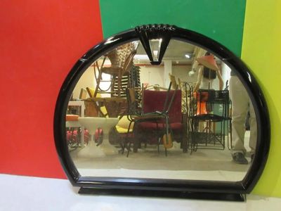 a mirror that is sitting on a table in front of a colorful wall
