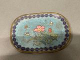a blue and gold box with flowers on it