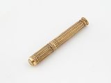an antique brass pipe with a wooden handle on a white surface