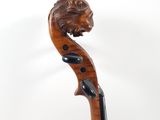a close up of a violin with a lion head on the back