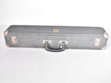a gray suitcase sitting on top of a white table