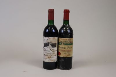 two bottles of wine sitting next to each other on a table