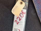 a luggage tag with a price tag attached to it