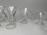 seven wine glasses sitting on a table with a white background
