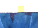 a close up of a piece of blue fabric with a wooden stick sticking out of it