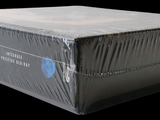 a box that is wrapped in plastic on a black background
