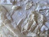 a pile of clothing that is laying on a bed
