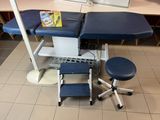 an image of a medical exam table with stools