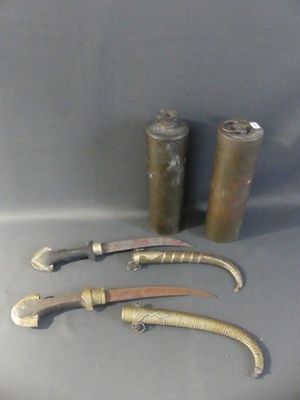 three knives and a canister are sitting on a table
