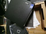 a black laptop sitting on top of a cardboard box