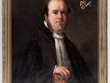 portrait of a man in a black coat and white shirt holding a book