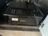 a canon printer that is sitting on a counter