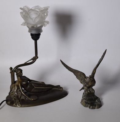 a white rose sitting on top of a table next to a lamp