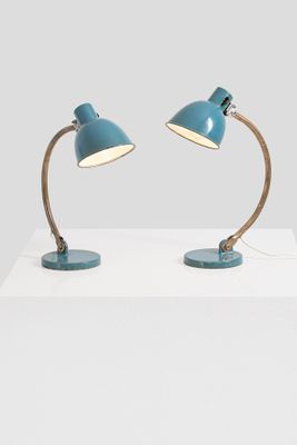 a pair of blue desk lamps on a white table