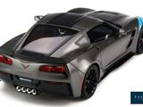 the gray and blue sports car is parked on a white surface