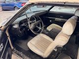 a car that has been burnt out and is sitting in the parking lot