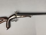 an old gun with a wooden handle on a white background