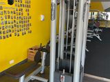a yellow wall with pictures on it and a gym equipment
