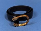 a close up of a black belt with a gold buckle on it