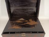 a small wooden box that has a picture of a mountain in it