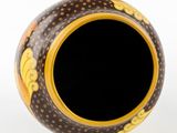 a vase that has a black and yellow design on it