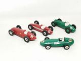 several toy cars are lined up in a row on a white surface