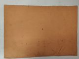 an old piece of brown paper with a hole in the middle of it