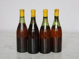 three bottles of wine are lined up on a marble surface
