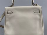 a white leather handbag on a grey background