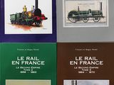 quatre livres posés sur une table, avec des images de trains sur la couverture