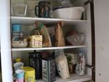 a cabinet with a lot of food and drinks in it