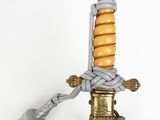 a gold and silver sword with a crown on it