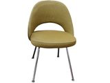the saarik chair with chrome legs is upholstered and has a mustard colored upholstered seat