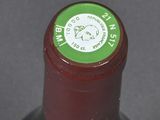 a bottle of wine that has a green label on it
