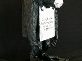 a statue of a gorilla with a sign on it ' s chest