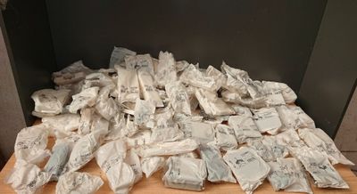 a pile of bags of food on a wooden table