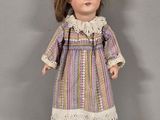 a close up of a doll wearing a dress and boots