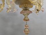 a gold chandelier hanging from the ceiling in a room