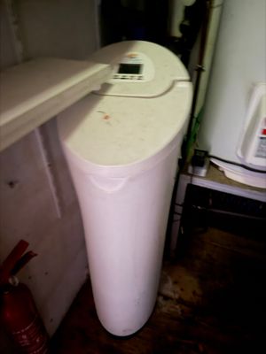 an image of a water purifier in the corner of a room