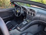 a dashboard of a sports car with a steering wheel