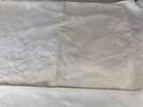 a bed with a white blanket and a white pillow