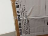 a cardboard box with a label on it sitting on the floor