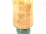 a green lamp with a wooden shade on it