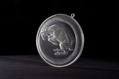 an image of a silver coin with a picture of a monkey on it