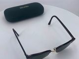 sunglasses on a table with a black case and a pair of glasses