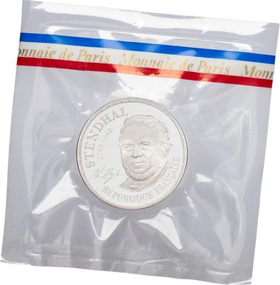 a close up of a coin in a plastic bag on a white background