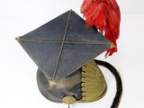 a hat with a red feather on top of it