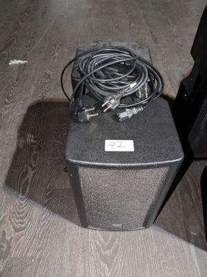 a black speaker sitting on top of a wooden table