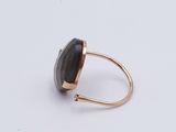 a close up of a ring with a black stone on it